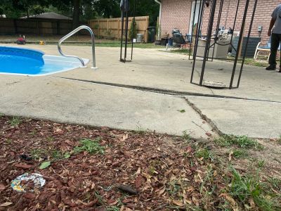cracking and uneven concrete next to a swimming pool